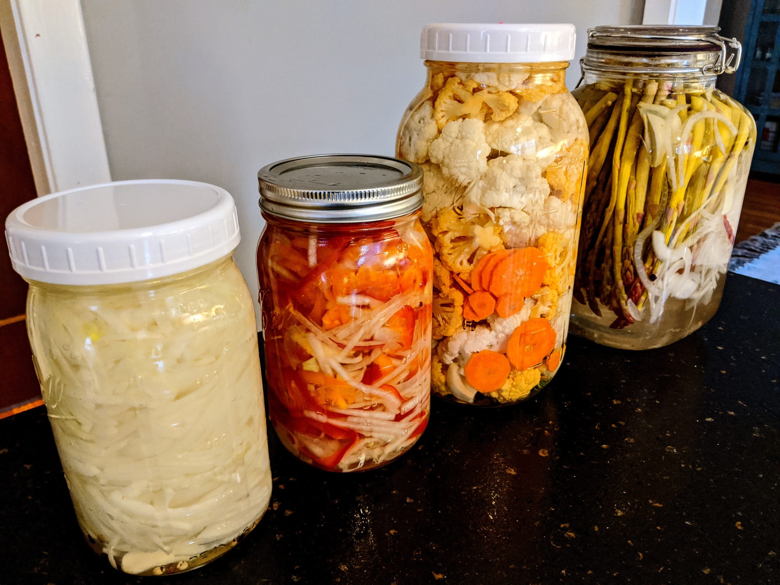 Pickled onions, cauliflower, and asparagus.